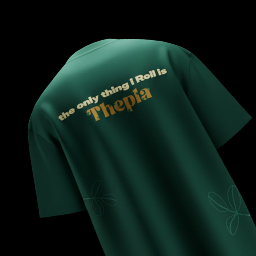 spankers Green t-shirt with text 'the only thing I roll is Thepla' on a black background