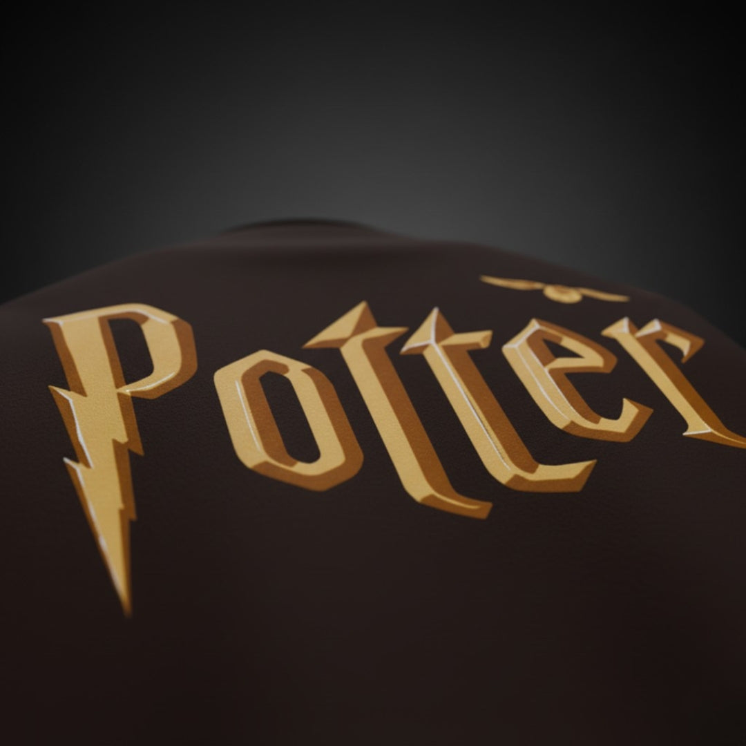 Close-up of a dark brown surface with 'Potter' in gold letters on a black background ( brown tshirt , chocolate brown tshirt , oversized , potter , harry potter tshirt , potter fan , spankers , spankers india , tshirt )