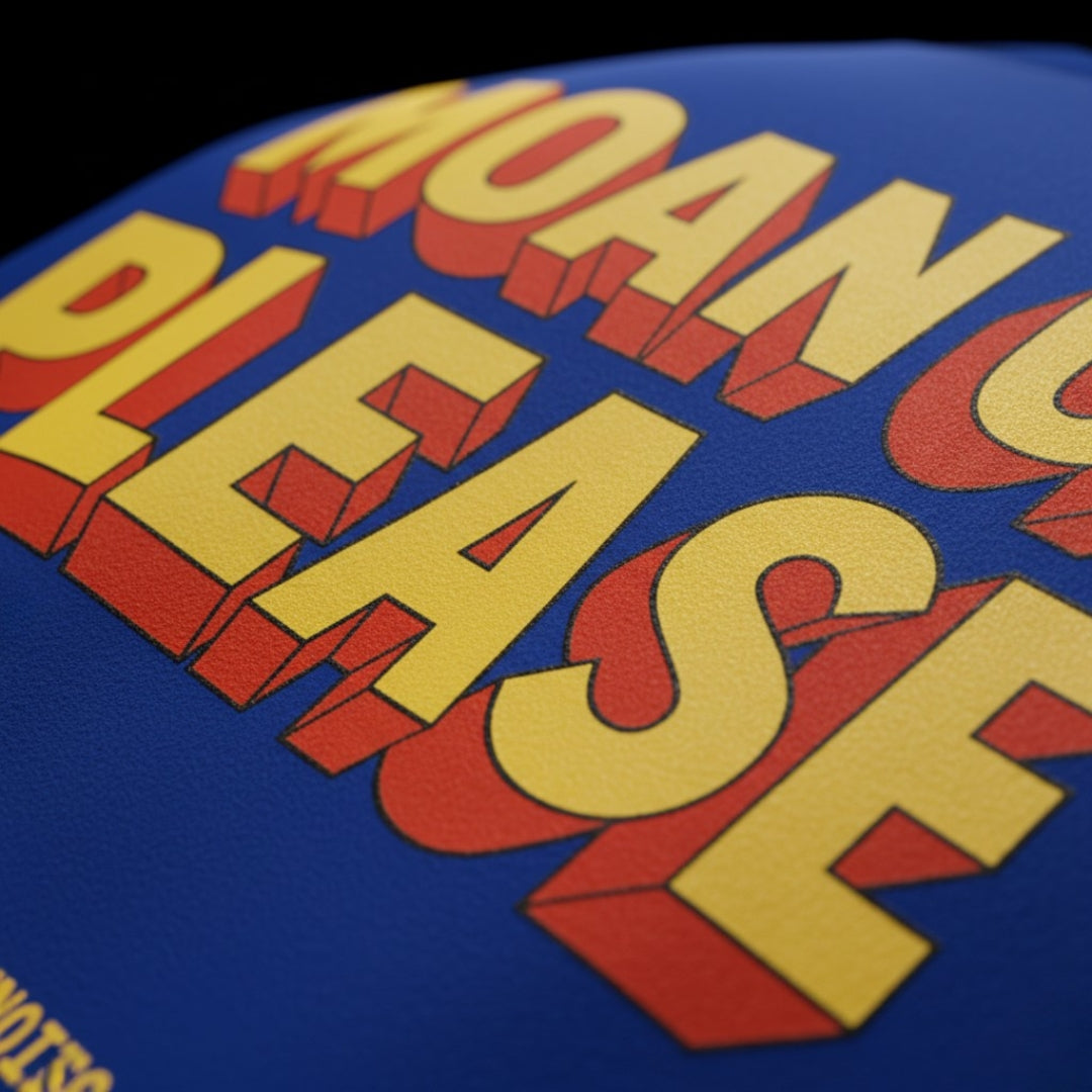 Close-up of a blue surface with red and yellow text. screen printing tshirt ( blue tshirt , royal blue  tshirt , oversized , potter , moan ok please  tshirt , moan is music and horn is noise  , spankers , spankers india , tshirt )