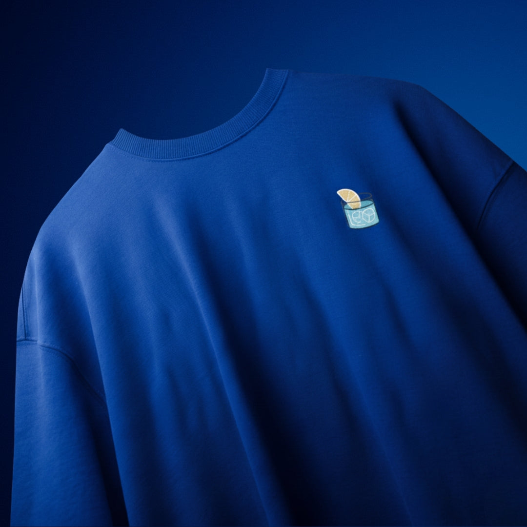 spankers blue t-shirt Blue sweatshirt with a small logo on the chest against a dark blue background