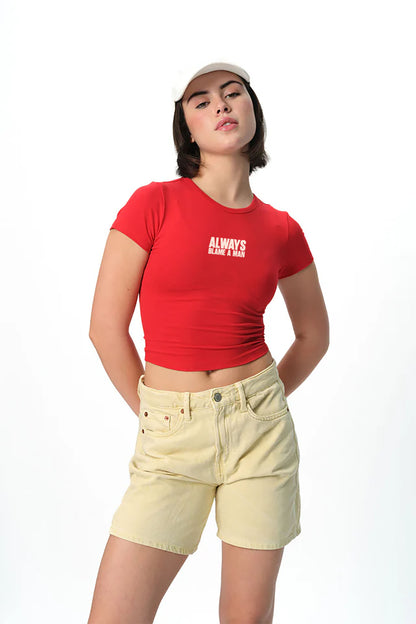spankers Person wearing a red tank top  with text and beige shorts on a white background
