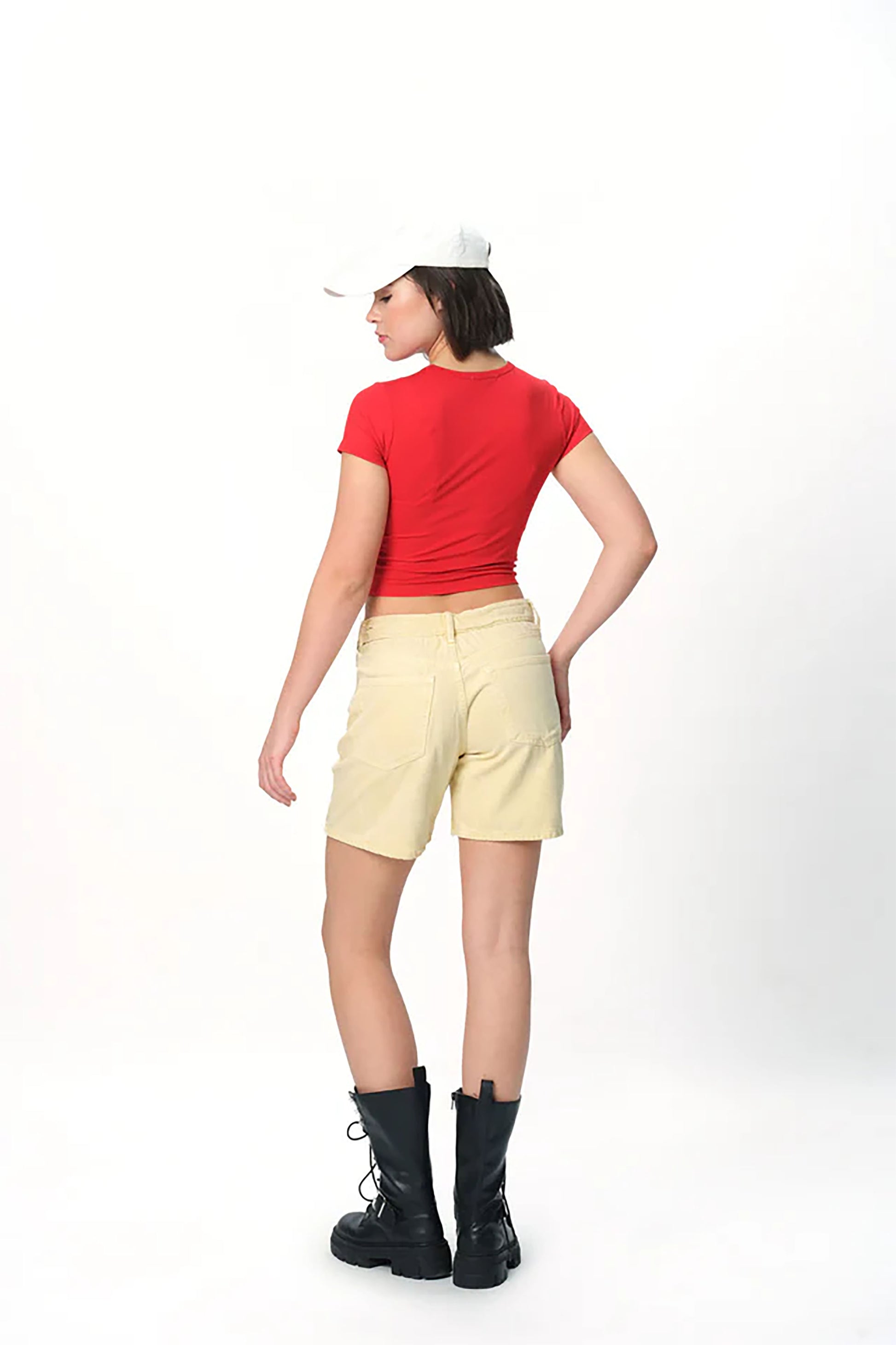 spankers Person wearing a red shirt, yellow shorts, and black boots on a white background