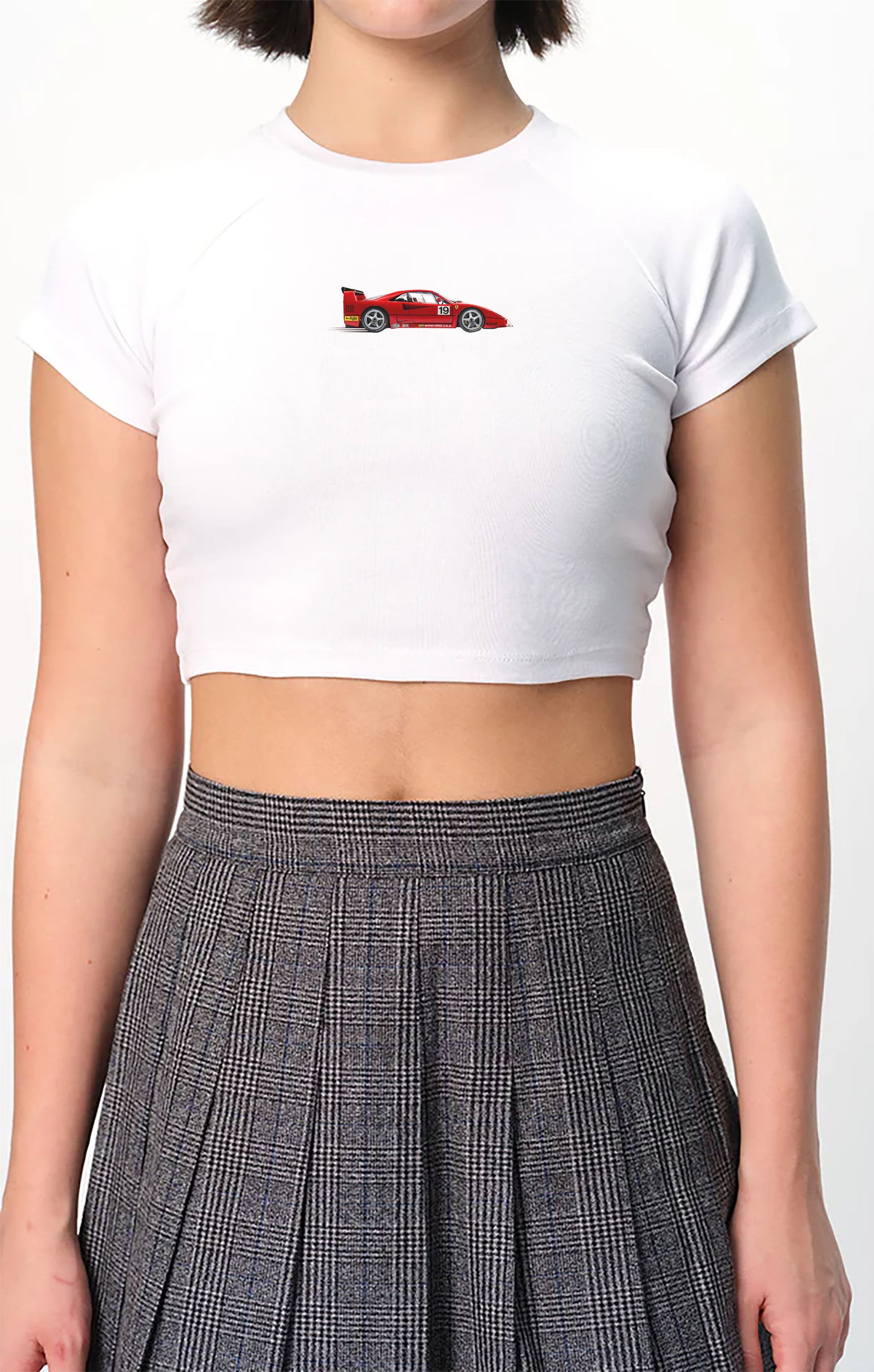 spankers Person wearing a white crop top with a red graphic and a plaid skirt on a white background