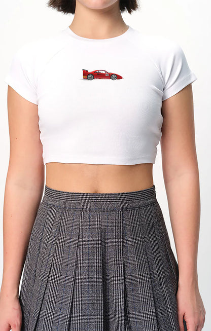 spankers Person wearing a white crop top with a red graphic and a plaid skirt on a white background