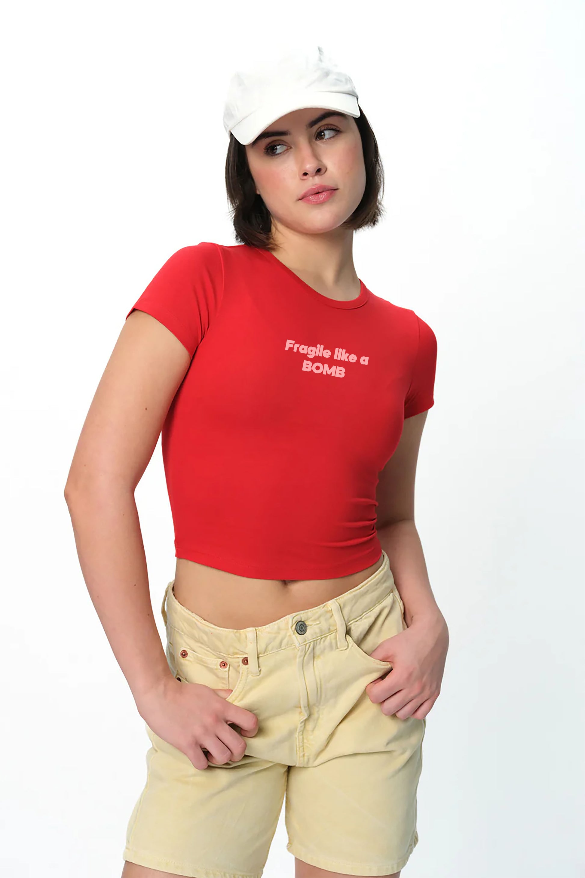 spankers Person wearing a red crop top with text and light-colored shorts on a white background