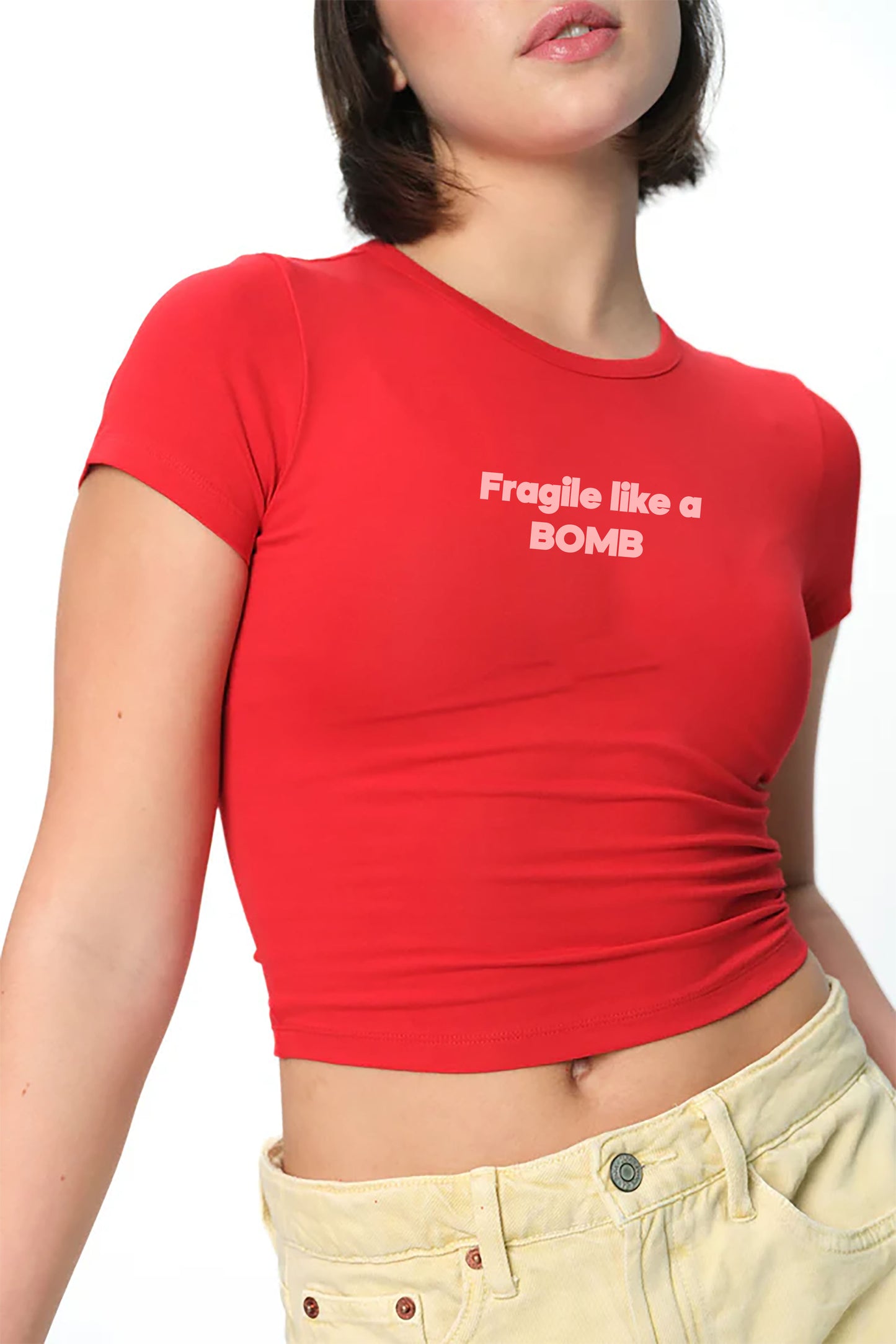 spankers  Red t-shirt with 'Fragile like a BOMB' text worn by a person on a white background