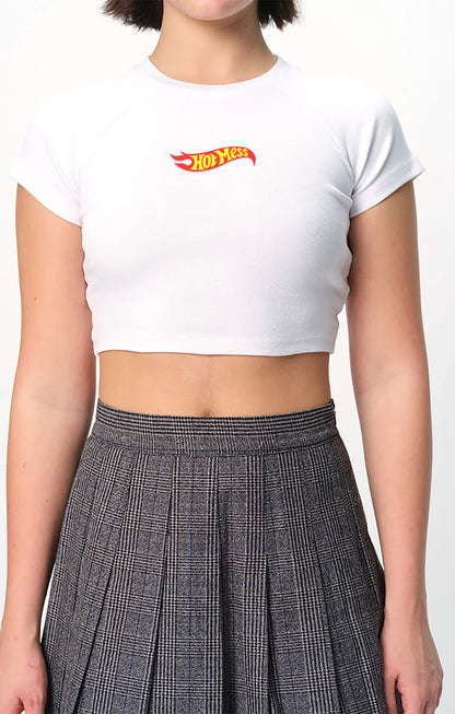 spankers Person wearing a white crop top with a red and yellow hot messc  and a plaid skirt.