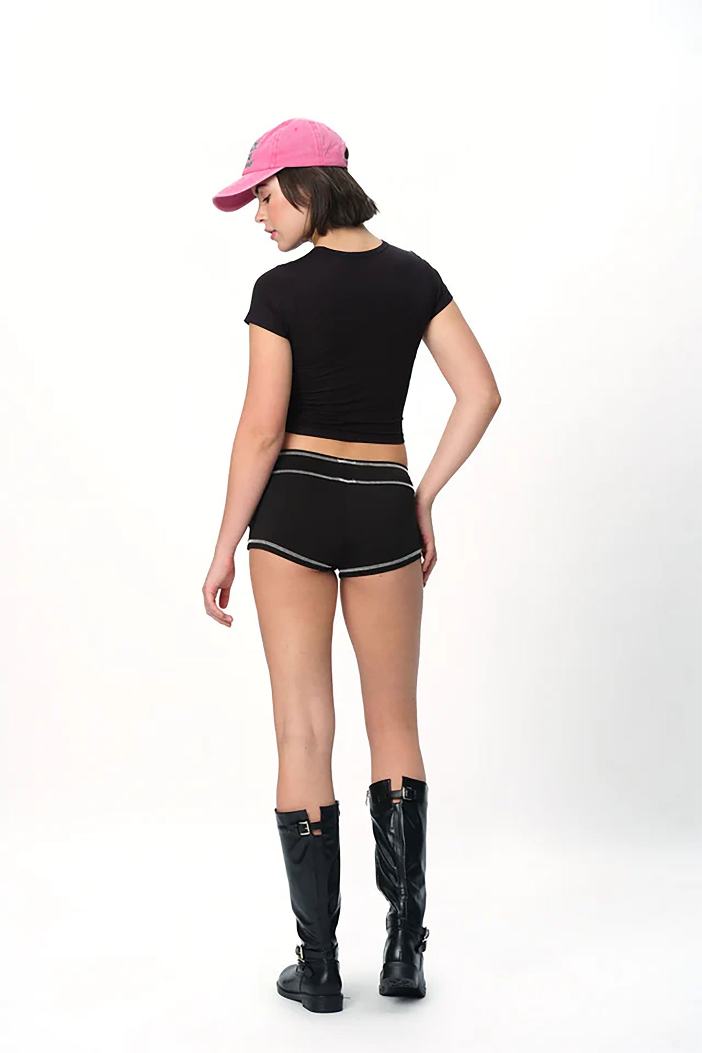 spankers Person wearing a black outfit with a pink cap on a white background